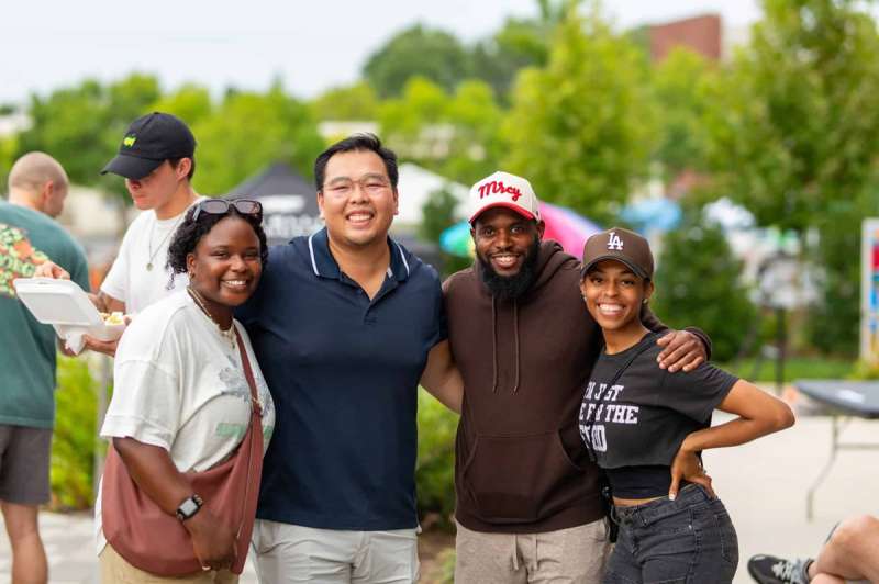 A group of friends attending a free outdoor concert in Chamblee, Georgia