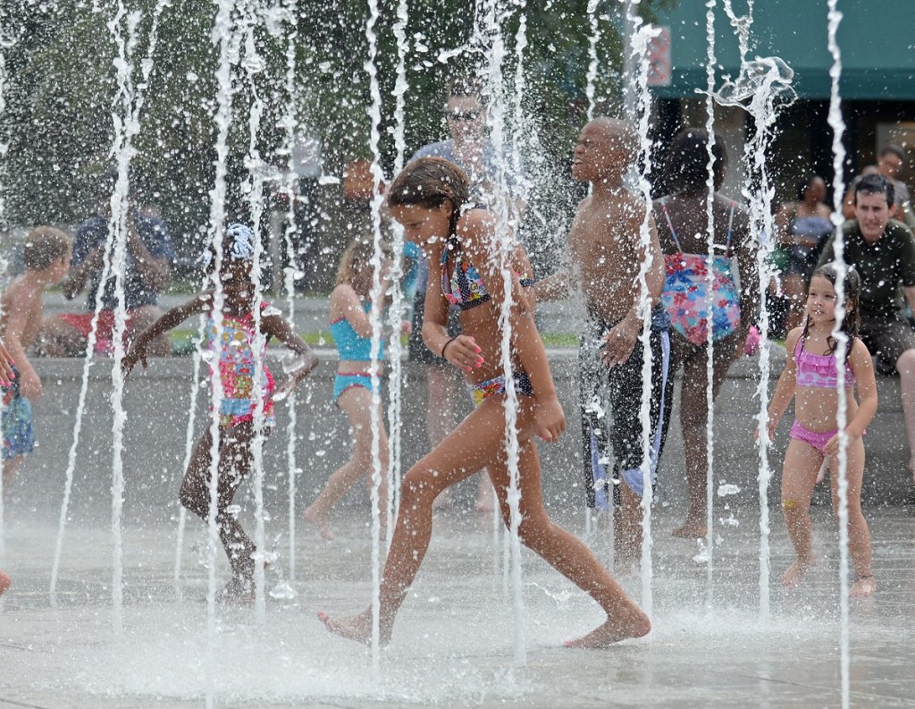 Children play in a splash pad during a Georgia heat wave