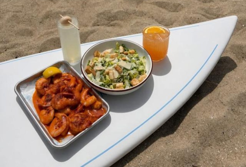 Food laid out on a surfboard to showcase waterfront dining in Savannah